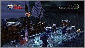 Za bramą trafimy na most z zielonym klockiem - kładziemy na niego rakietę, która będzie z prawej, a następnie podpalamy jej lont pochodnią - Singapur - opis przejścia | Na krańcu świata | LEGO Piraci z Karaibów - LEGO Piraci z Karaibów - poradnik do gry