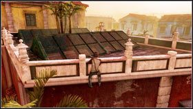 Wskakujemy na zadaszenie klatki schodowej [1] znajdujące się po prawej stronie, a następnie przeskakujemy na taras [2] i udajemy się na jego koniec - Rozdział 3- Robota na poziomie | Opis przejścia Uncharted 3 Oszustwo Drakea - Uncharted 3: Oszustwo Drakea - poradnik do gry