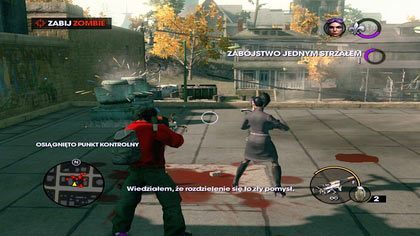 Po zrzuceniu pojemnika Viola dzwoni do nas, iż nie może poradzić sobie z atakującymi ją zombie - biegniemy do niej czym prędzej i pozbywamy się przeciwników - Atak zombie | Kampania Saints Row The Third - Saints Row: The Third - poradnik do gry