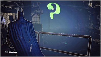 Jeżeli zbadasz z pomocą trybu detektywa okolice oznaczonego przez grę punktu, to zauważysz, że znajduje się tam niekompletny pytajnik (powyższy screen) - Dzielnica przemysłowa - Zagadki słowne, Kamery TYGERA | Zagadki - Batman: Arkham City - poradnik do gry