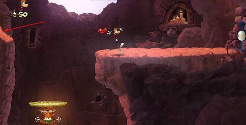 Kiedy wydostaniesz się na zewnątrz góry korzystając z bujawki i skoku od ściany złap S - Magiczne Małpki (300 L, 3:00); Droga Elektrunów (175 L) | Mistyczny Szczyt - Rayman Origins - poradnik do gry