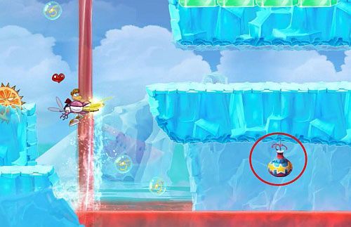 Na końcu poziomu, za drzwiami z okiem czeka oczywiście klatka z E - Coś się tak napalił! (300 L) | Słodkie Jeziora | Rayman Origins - Rayman Origins - poradnik do gry