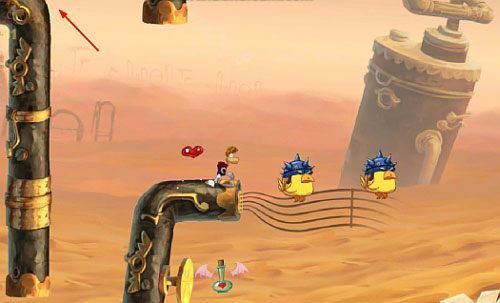 Za drzwiami z okiem po minięciu LK i zebraniu 14 L (w tym 3 po minięciu roślinki na najniższym poziomie) dotrzesz do papugi, na którą naskocz i natychmiast odbij się od niej w prawą stronę, aby uzyskać M - Najlepszy podkład muzyczny (300 L, 2:00) | Pustynia Dijirdów | Rayman Origins - Rayman Origins - poradnik do gry