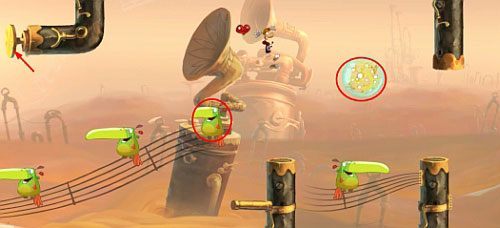 Za drzwiami z okiem znajdziesz ostatnią na tym poziomie klatkę z E, której zniszczenie zakończy poziom - Najlepszy podkład muzyczny (300 L, 2:00) | Pustynia Dijirdów | Rayman Origins - Rayman Origins - poradnik do gry