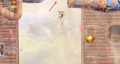 Po przejściu przez drzwi z okiem skocz z atakiem na bęben, odbijaj się od ścian, a dotrzesz do M - Wiatr albo przewóz (300 L, 2:20) | Pustynia Dijirdów | Rayman Origins - Rayman Origins - poradnik do gry