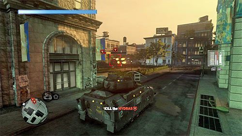 Polecam rozważyć dwie taktyki działania, a mianowicie chować się za ścianami budynków, wyjeżdżając zza nich jedynie w celu wystrzelenia kilku rakiet (powyższy screen), lub jeździć w tę i z powrotem po jednej z okolicznych dróg, stanowiąc tym samym trudny cel dla potworów - 14 - Enemies and Allies | Główny wątek fabularny Prototype 2 - Prototype 2 - poradnik do gry