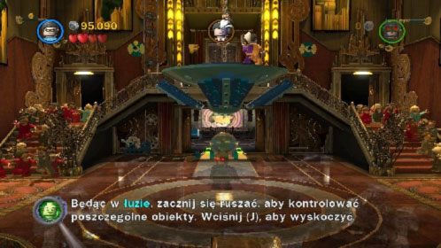 Przełącz się na Batmana, włącz niewidzialność i omiń kamery znajdujące się przed wejściem do pomieszczenia pod podestem na którym stoi Dwie Twarze - Na deskach teatru | Opis przejścia LEGO Batman 2 DC Super Heroes - LEGO Batman 2: DC Super Heroes - poradnik do gry