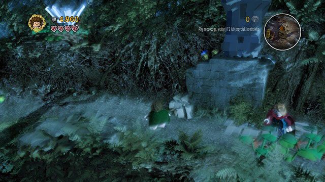 Uderzając w niewielki głaz znajdujący się pod naszymi nogami zdobędziemy kamień - wykorzystamy go do zrzucenia z gałęzi widmowych klocków LEGO - Amon Hen | Opis przejścia - Akt I | LEGO The Lord of the Rings - LEGO The Lord of the Rings: Władca Pierścieni - poradnik do gry