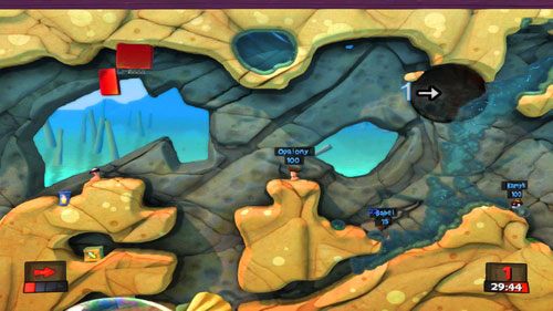 W pierwszej kolejności, używając Bazooki, strzelamy w punkt między butelką a wrogim robalem [1], dzięki czemu pozbędziemy się pierwszego przeciwnika oraz muszelki która zagradza nam drogę do skrzynki - Bijatyka na plaży | Plaża (Kampania) | Worms Revolution - Worms: Revolution - poradnik do gry