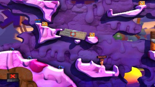 Po zebraniu dwóch skrzynek, mierzymy z Telekinezy w stronę tabliczki czekolady, a następnie przenosimy ją we wskazane miejsce, by utworzyć most [ilustracja] - Wszystkie atrakcje wesołego miasteczka! | Łamigłówki | Worms Revolution - Worms: Revolution - poradnik do gry