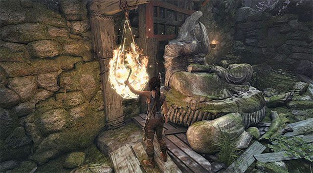 Proces pozyskiwania surowców możesz przyśpieszyć zajmując się podpalaniem pokazanych na screenie siatek (musisz najpierw zapalić posiadaną pochodnię przy jednej z lamp) - Zbierz 50 jednostek surowców z zamiarem ulepszenia czekana | 6 - W impasie - Tomb Raider - poradnik do gry