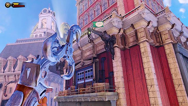 Po wyjściu na taras za restauracją, spójrz w górę, na czerwono-biały budynek, unoszący się nieopodal - Idź na Wyspę Pomnika i odszukaj dziewczynę (1) | Rozdział 4 - Dachy Centrum Comstocka - BioShock: Infinite - poradnik do gry