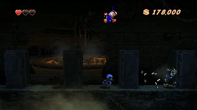 Tego typu trumienki można niszczyć uderzając w nie laską, a to czy znajdziemy w nich klejnot czy ducha pozostaje już jedynie kwestią przypadku - Główne korytarze, mury i lochy | Transylwania | DuckTales - DuckTales Remastered - poradnik do gry