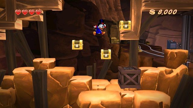 Przed podejściem do dziwnej maszynerii wpierw należy zniszczyć niewidzialne skrzynki. W innym wypadku nie będziemy mogli ich już potem otworzyć. - Wejście do kompleksu | Afrykańskie kopalnie | DuckTales - DuckTales Remastered - poradnik do gry