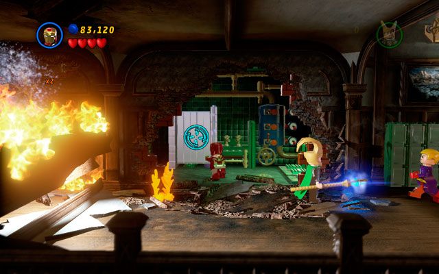 Przejdź trochę w prawo i za płonącym zawaliskiem wybierz Iron Mana, strzelając rakietami do srebrnej ubikacji - Juggernauts and Crosses | Zestawy MiniKit w LEGO Marvel Super Heroes - LEGO Marvel Super Heroes - poradnik do gry