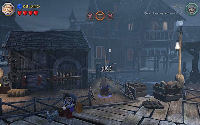 Zeskocz na dół i wyrusz w prawo, zatrzymując się przy odnalezionej niedaleko stąd kolejnej zagrodzie - Etap 12 (A Warm Welcome) - Doki - LEGO The Hobbit - poradnik do gry