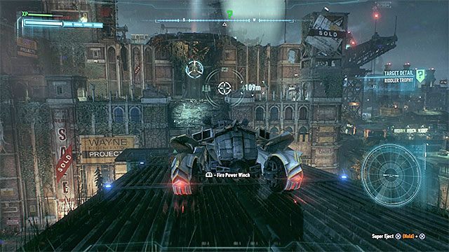 Ostrożnie przejeżdżaj po kolejnych dachach (możesz pomagać sobie trybem bojowym batmobilu) - Trofea Człowieka-Zagadki na wyspie Bleake Island (19-36) | Wyspa Bleake Island - Batman Arkham Knight - poradnik do gry