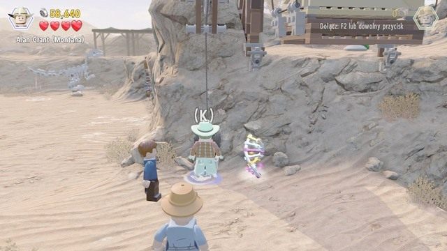 Wróć teraz na lewą stronę, do miejsca pokazanego na obrazku i postacią Alana aktywuj dźwignię, naciskając szybko pojawiający się na ekranie przycisk - Prolog | Jurasic Park - opis przejścia - LEGO Jurassic World - poradnik gry