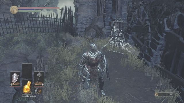 Za budynkiem znajdziesz gadającą klatkę. - Osada Nieumarłych - od dużego placu, droga w prawo przez most | Opis przejścia - Dark Souls III - opis przejścia i sekrety