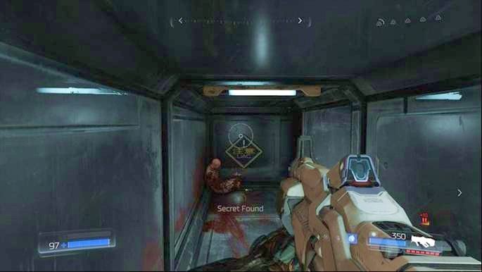 Gdy walka z pierwszymi Opętanymi Żołnierzami dobiegnie końca, przejdź do lokacji obok, otwórz skrzynię z amunicją, a następnie obejdź duże skrzynie leżące obok - Laboratoria Lazarus | Sekrety | Doom - Doom - poradnik do gry