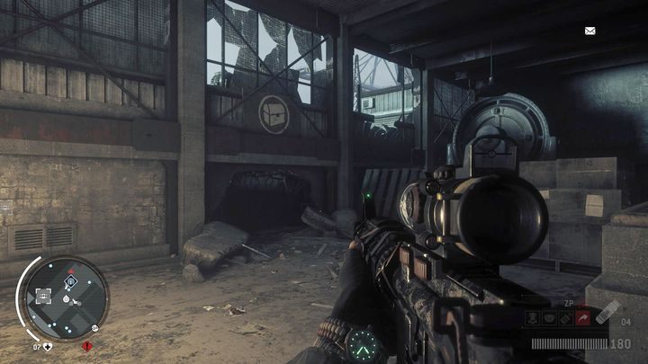 Wejście do magazynu piątego znajdziesz w hangarze, w miejscu pokazanym na obrazku - Czerwona strefa Elmtree | Magazyny i zlecenia - Homefront: The Revolution - poradnik do gry