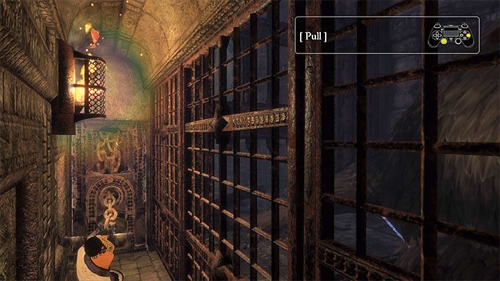 Skorzystanie z uchwytu pozwoli podnieść bramę i uwolnić Trico - Podniesienie bramy przygniatającej ogon Trico | The Last Guardian - The Last Guardian - poradnik do gry