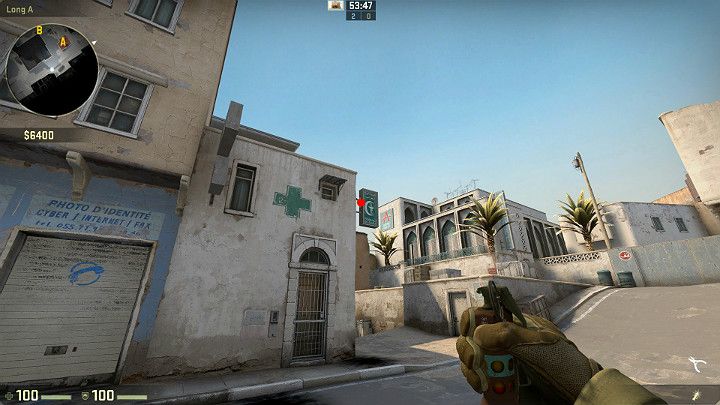 Wyceluj pomiędzy dwoma rurkami od oznaczonego bilboardu i wykonaj rzut korzystając z LPM - Dust 2 | Mapy Turniejowe | CS GO - CS GO - poradnik do gry