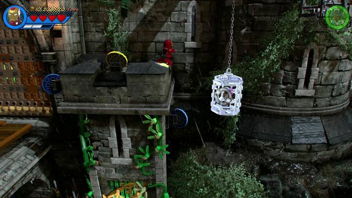 Wleć na mur po prawej stronie (patrz obrazek) i zniszcz srebrną klatkę, w której uwięziony został Stan Lee - Sekrety Misja 3 - Czarno to widzę | LEGO Marvel Super Heroes 2 - LEGO Marvel Super Heroes 2 - poradnik do gry