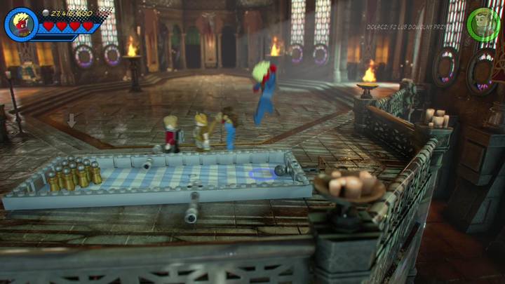 Podejdź do stołu z grą umieszczoną na ziemi w pokazanym na obrazku miejscu (w komnacie) i skorzystaj ze sprężyny po prawej stronie - Sekrety Misja 7 - Nerwowa natura Surtura | LEGO Marvel Super Heroes 2 - LEGO Marvel Super Heroes 2 - poradnik do gry