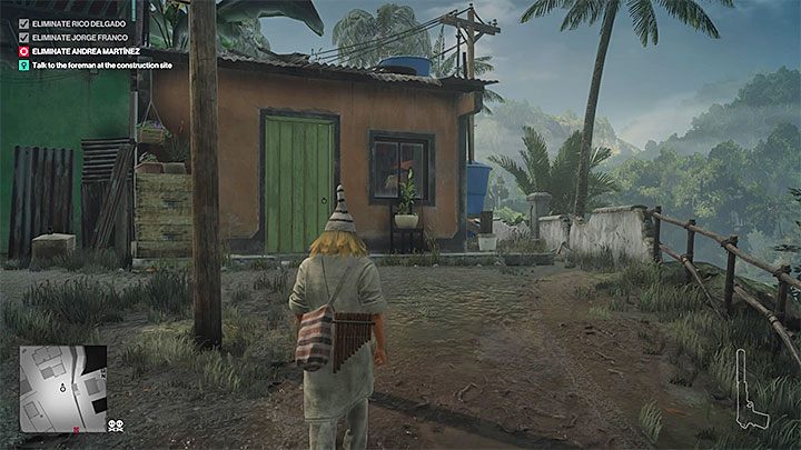 Dotrzyj w tym przebraniu do miasteczka i zainteresuj się pomarańczowym budynkiem z powyższego obrazka, z którego powinien wyjść jeden z mieszkańców - Hitman 2: Santa Fortuna - wszystkie trofea, lista - Hitman 2 - poradnik do gry