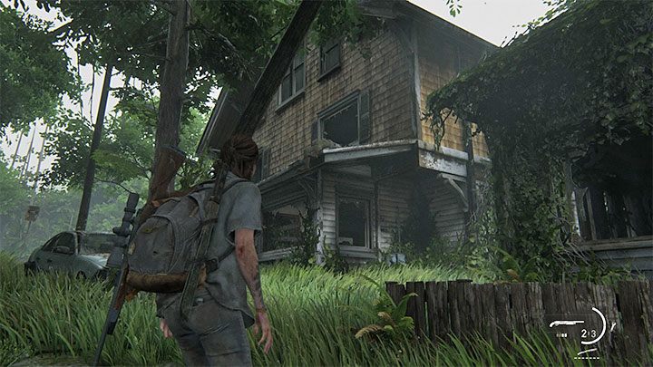 Musisz zbadać pokazany na powyższym obrazku ostatni budynek po prawej stronie zarośniętej drogi - The Last of Us 2: Hillcrest sekrety, znajdźki - The Last of Us 2 - poradnik do gry