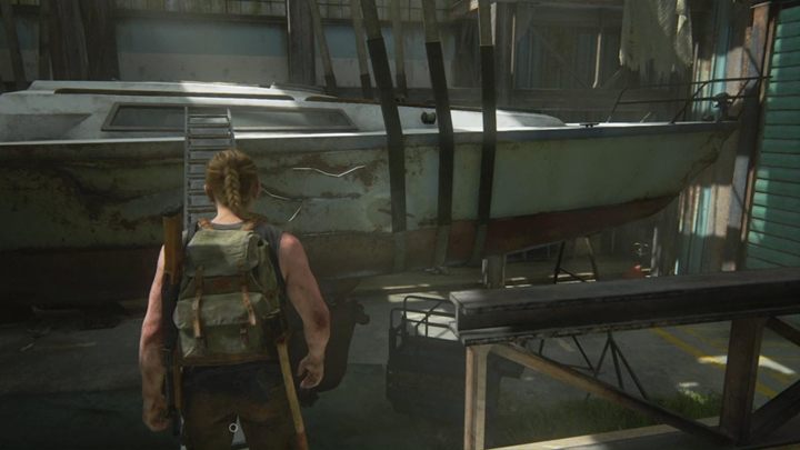 Dotrzesz do podwieszonej łódki - obok odnajdziesz położoną drabinę, umieść ją tak, by zahaczyła o statek i stworzyła pomost - The Last of Us 2: Pieszo - solucja, opis przejścia - The Last of Us 2 - poradnik do gry