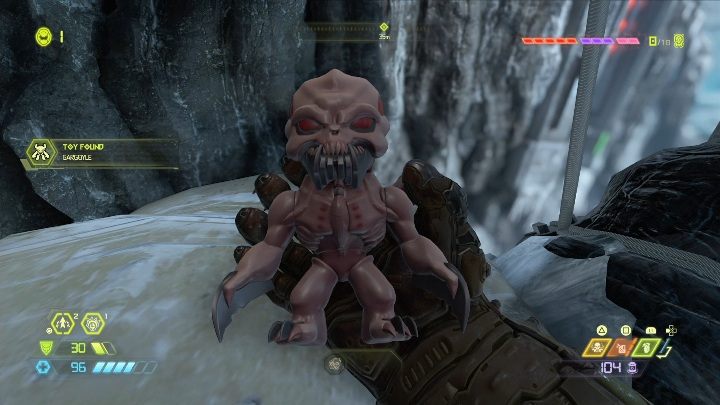 Teraz wystarczy, że zeskoczysz z półki skalnej na wielką kamienną głowę demona, a figurka wpadnie w twoje ręce - Doom Eternal: Baza kultystów | Mapa sekretów, znajdźki - Doom Eternal - poradnik do gry