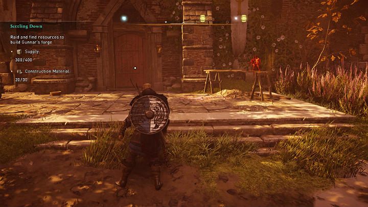 Zapasy potrzebne do ukończenia misji schowane są w głównym budynku, za zamkniętymi drzwiami - Assassins Creed Valhalla: Zapuszczanie korzeni/Settling Down - solucja - Assassins Creed Valhalla - poradnik do gry