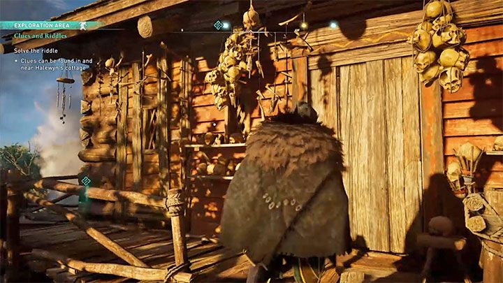 Piąty ślad wisi przy zamkniętych bocznych drzwiach chatki (zwróć kamerę ku wiszącym czaszkom) - Soul Skulls - Assassins Creed Valhalla: Jak rozwiązać zagadkę z łamigłówkami druida? - Assassins Creed Valhalla - poradnik do gry