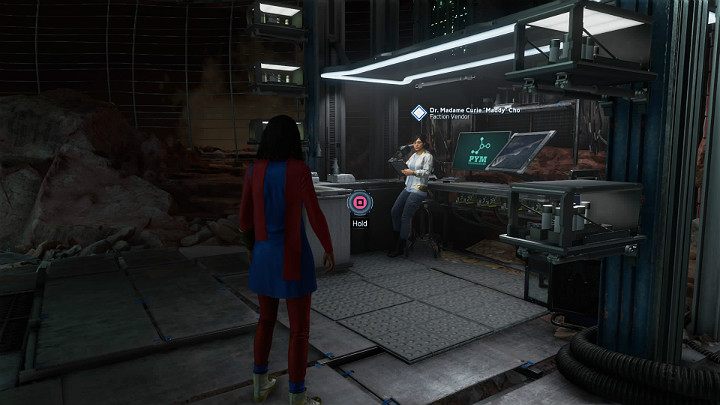 W drugiej kolejności pójdź odwiedzić NPC Dr Madame Curie Maddy Cho, która jest handlarzem frakcji (Faction Vendor) - Marvels Avengers: Psy wojny/The Dogs of War - solucja, opis przejścia - Marvels Avengers - poradnik do gry