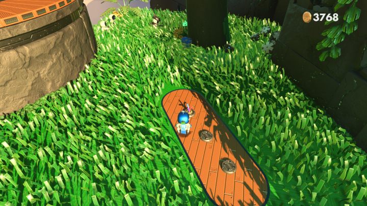 Przy okrągłej platformie znajdują się monety, ukryte pod kablami - Astros Playroom: Las renderów - solucja, opis przejścia - Astros Playroom - poradnik do gry