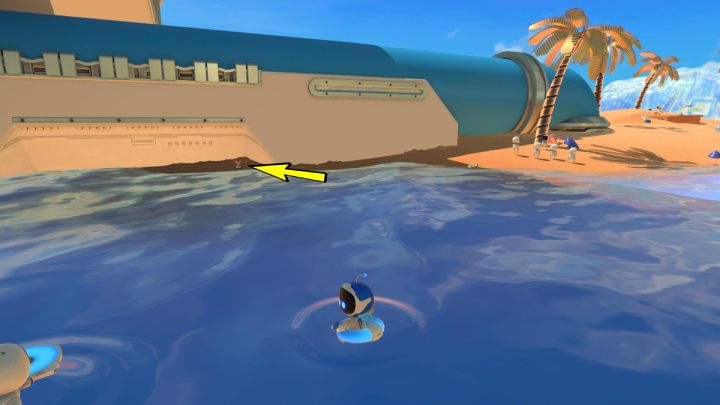 Przy dużej niebieskiej rurze wystają kable z piasku - Astros Playroom: Plaża botów - solucja, opis przejścia - Astros Playroom - poradnik do gry