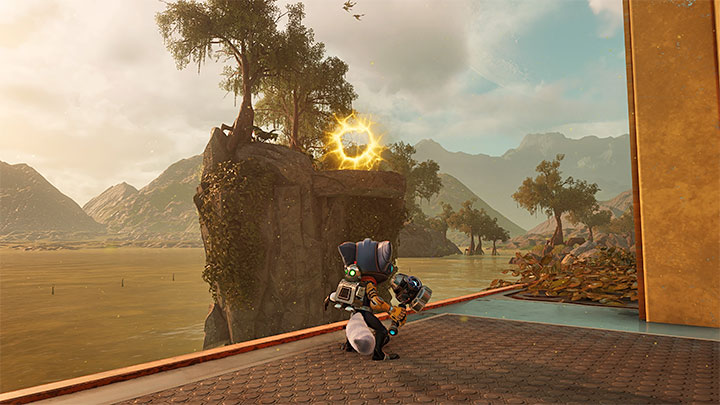 Zanim zainteresujecie się dwoma nowymi celami misji (opisaliśmy je w kolejnych podpunktach) udajcie się najpierw na tyły fabryki gelatonium - Ratchet & Clank Rift Apart: Zbadanie anomalii, kryjówka Rivet - solucja - Ratchet & Clank Rift Apart - poradnik do gry