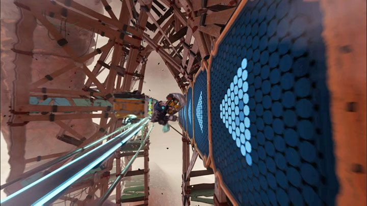 Nieco dalej pojawi się kolejna przeszkoda w postaci rzędu wagoników, nad którymi nie można bezpiecznie przeskoczyć - Ratchet & Clank Rift Apart: Ucieczka przed Naprawiaczem - solucja - Ratchet & Clank Rift Apart - poradnik do gry