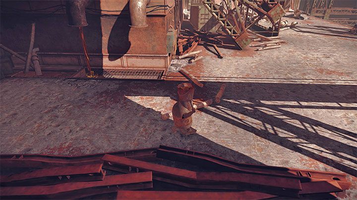 W drodze powrotnej wybierzcie drogę okrężną, bo sterowany przez Was robot może potknąć się o małe przeszkody na ziemi i przewrócić, przez co zmuszeni zostaniecie do ponownego napełnienia wiadra - NieR Automata: 1 Rozdział, Route B - solucja, opis przejścia - NieR Automata - poradnik do gry