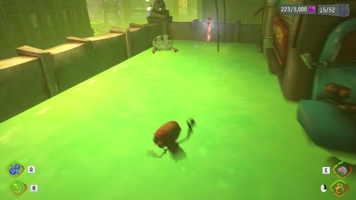 Ta zawieszka znajduje się na budynku z zieloną mazią - Psychonauts 2: Emotional Baggage, Strike City - gdzie znaleźć? - Psychonauts 2 - poradnik do gry