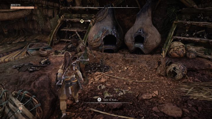 Skorzystajcie z pakietu szybkiej podróży, aby przetransportować się do ogniska, przy którym czeka Kue i porozmawiajcie z nim - Horizon Forbidden West: Korzenie, które łączą (The Roots That Bind) - solucja, opis przejścia - Horizon Forbidden West - poradnik do gry