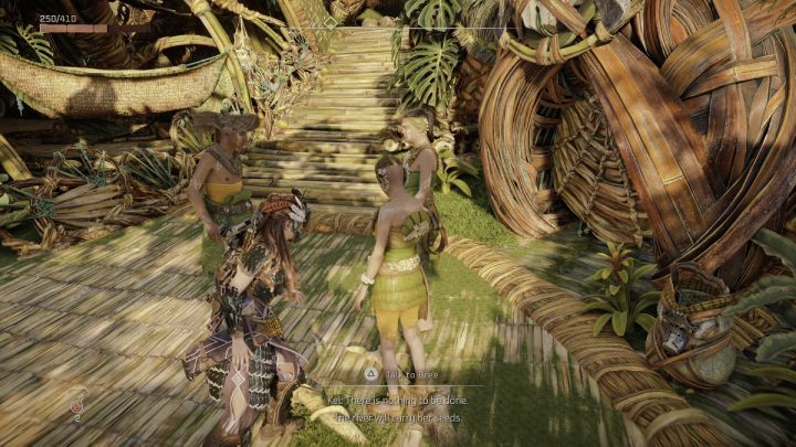 Porozmawiajcie z grupą ludzi przy schodach w osadzie Pieśń Ziemi, w pobliżu sprzedawcy strojów - Horizon Forbidden West: Taras (The Promontory) - solucja, opis przejścia - Horizon Forbidden West - poradnik do gry