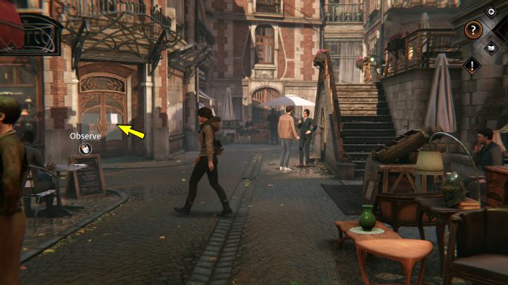 Sklep Mullera znajduje się przy kafejce, niedaleko schodów do restauracji Take Five - Syberia The World Before: Vaghen - Dzielnica antykwariuszy, jesień 2005 (Vaghen - Antiques district, jesień 2005) - solucja, opis przejścia - Syberia The World Before - poradnik do gry