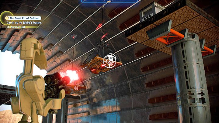 W dotarciu do klocka pomogą Wam wiszące platformy, przy czym domyślnie niektóre z nich są za bardzo od siebie oddalone i nie pomoże nawet podwójny skok - LEGO Skywalker Saga: Osada Niima (Niima Outpost) - lista wszystkich łamigłówek - LEGO Skywalker Saga - poradnik do gry