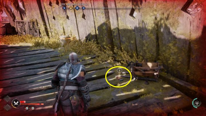 Znajdźka leży koło drewnianej skrzynki z narzędziami i czerwonego naczynia - God of War Ragnarok: Platforma Radsvinna (Radsvinns Rig), Svartalfheim - sekrety, znajdźki - God of War Ragnarok - poradnik do gry