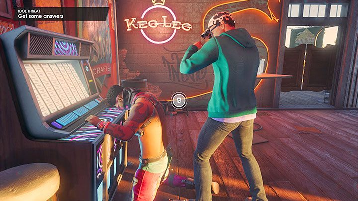 Podejdźcie w barze do członka gangu Idolów stojącego przy maszynie grającej - Saints Row 2022: Groźni idole (Idol Threat) - solucja, opis przejścia - Saints Row - poradnik do gry