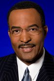 Off-Screen TV Anchor (voice)