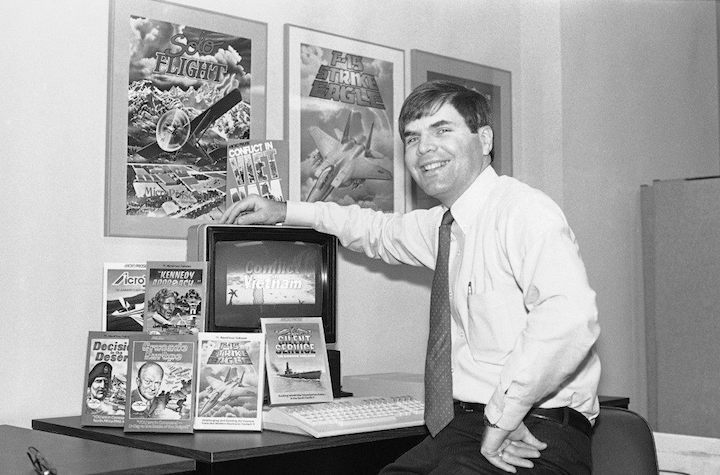 John "Wild Bill" Stealey and the covers of MicroProse's first hits (AP Photo/Bill Smith). - Like Phoenix from Ashes – The Story of MicroProse - dokument - 2020-06-04